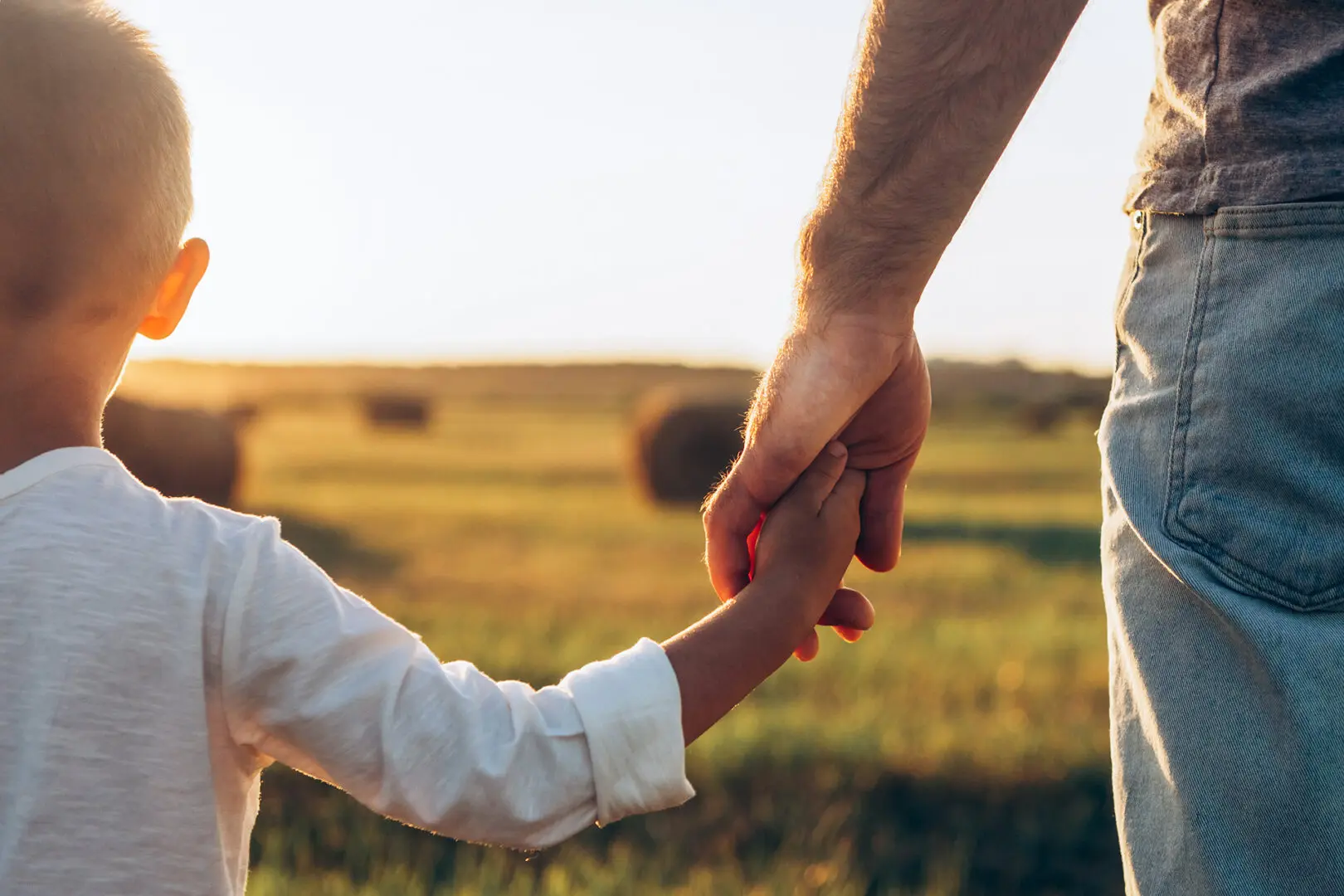 A father holding his sons hand after getting custody. He hired a Child Custody Lawyer that he could trust in Atlanta.